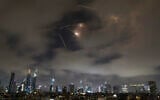 Israeli air defenses fire intercept missiles during an Iranian attack over Tel Aviv, early June 21, 2025. (AP Photo/Leo Correa)