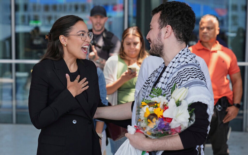 Anti-Israel activist Mahmoud Khalil, right, speaks to US Representative Alexandria Ocasio-Cortez, a New York Democrat, after arriving at Newark International Airport, June 21, 2025, in Newark, New Jersey. (AP Photo/Seth Wenig)