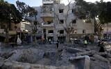 Firemen and rescue workers survey the site where a missile launched from Iran struck in Haifa, Israel, June 22, 2025. (AP Photo/Baz Ratner)