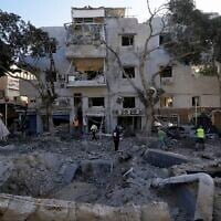 Firemen and rescue workers survey the site where a missile launched from Iran struck in Haifa, Israel, June 22, 2025. (AP Photo/Baz Ratner)