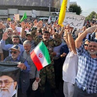 Protesters carry Iranian national flags and a poster of Islamic Republic founder Ayatollah Khomeini, left, and Supreme Leader Ayatollah Ali Khamenei, while chanting anti-US and -Israel slogans after the attacks on nuclear sites in Iran, in Tehran, Iran, June 22, 2025. (AP Photo/Vahid Salemi)