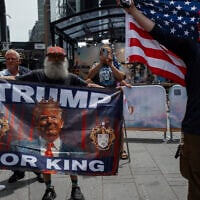 Supporters of President Donald Trump hold pro-Trump flags in Times Square amid a protest against US strikes on Iran,  June 22, 2025, in New York. (AP Photo/Olga Fedorova)