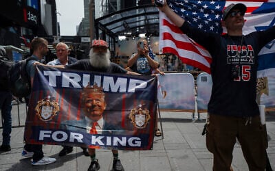 Supporters of President Donald Trump hold pro-Trump flags in Times Square amid a protest against US strikes on Iran,  June 22, 2025, in New York. (AP Photo/Olga Fedorova)