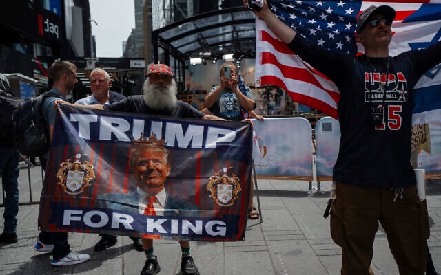 Supporters of President Donald Trump hold pro-Trump flags in Times Square amid a protest against US strikes on Iran,  June 22, 2025, in New York. (AP Photo/Olga Fedorova)