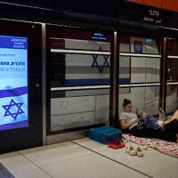 People take shelter in an underground metro station as air raid sirens warn of incoming strikes by Iran, in Tel Aviv, June 22, 2025. (AP Photo/Ohad Zwigenberg)