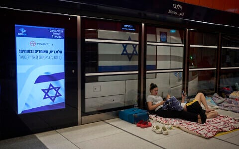 People take shelter in an underground metro station as air raid sirens warn of incoming strikes by Iran, in Tel Aviv, June 22, 2025. (AP Photo/Ohad Zwigenberg)