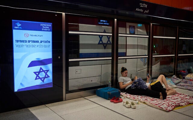 People take shelter in an underground metro station as air raid sirens warn of incoming strikes by Iran, in Tel Aviv, June 22, 2025. (AP Photo/Ohad Zwigenberg)