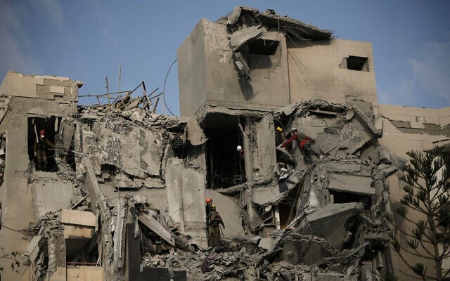 Israeli soldiers and rescue team search for survivors amid the rubble of residential buildings destroyed by an Iranian missile strike that killed several people, in Beersheba, Israel, on June 24, 2025. (AP Photo/Leo Correa)