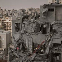 Israeli soldiers and rescue team work amid the rubble of residential buildings destroyed by an Iranian missile strike that killed several people, in Beersheba, Israel, June 24, 2025. (AP Photo/Leo Correa)