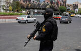 A member of Iran's Islamic Revolutionary Guard Corps stands guard at Enqelab-e-Eslami (Islamic Revolution) square in downtown Tehran, June 24, 2025. (AP Photo/Vahid Salemi)