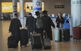 Travelers walk with their luggage following the announcement of a ceasefire between Israel and Iran, at Ben Gurion Airport, near Tel Aviv, June 25, 2025. (AP/Ohad Zwigenberg)