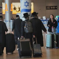 Travelers walk with their luggage following the announcement of a ceasefire between Israel and Iran, at Ben Gurion Airport, near Tel Aviv, June 25, 2025. (AP/Ohad Zwigenberg)