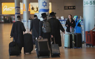 Travelers walk with their luggage following the announcement of a ceasefire between Israel and Iran, at Ben Gurion Airport, near Tel Aviv, June 25, 2025. (AP/Ohad Zwigenberg)
