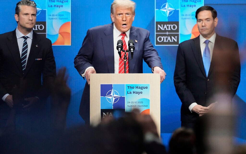 President Donald Trump speaks standing between Secretary of State Marco Rubio, right, and Defense Secretary Pete Hegseth during a press conference after the plenary session at the NATO summit in The Hague, Netherlands, Wednesday, June 25, 2025. (AP Photo/Markus Schreiber)