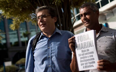 Ivo Herzog, left, son of journalist Vladimir Herzog who was killed in 1975 during the military dictatorship, accompanies Congressman Romario in Rio de Janeiro, April 1, 2013. (AP/Felipe Dana)