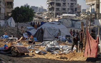 Palestinians inspect damaged tents after an Israeli strike hit a displacement camp in Gaza City, Saturday, June 28, 2025. (AP Photo/Jehad Alshrafi)