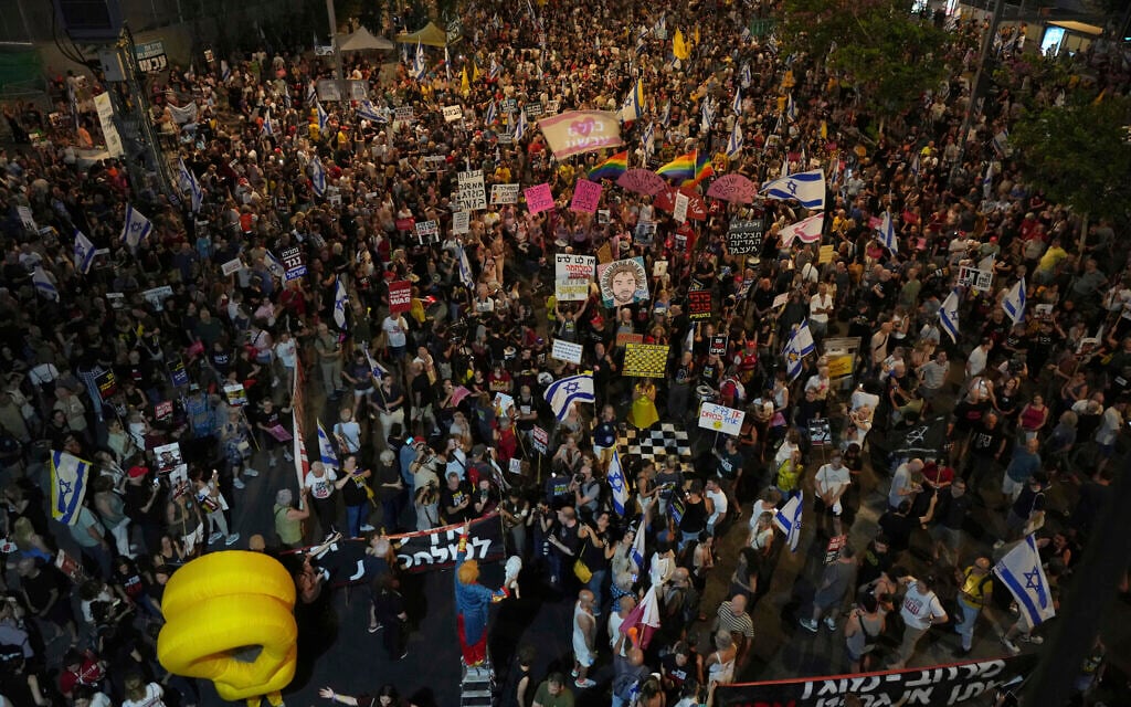 People take part in a protest demanding the end of the war and immediate release of hostages held by Hamas in the Gaza Strip, and against Prime Minister Benjamin Netanyahu's government, in Tel Aviv on June 28, 2025. (AP Photo/Ariel Schalit)
