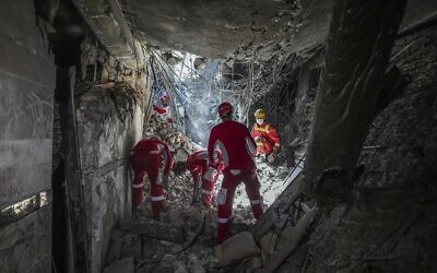 Rescuers search through the rubble of a damaged section of Evin Prison following an Israeli strike the day before, in Tehran, Iran, June 24, 2025. (Mostafa Roudaki/Mizan News Agency/AP)