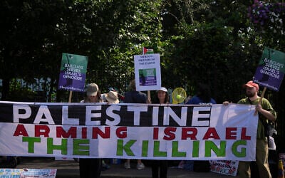 Protesters of the Palestine Solidarity Campaign against the tournament's sponsor Barclays gather outside the Wimbledon Tennis Championships in London, June 30, 2025. (AP Photo/ Alastair Grant)