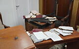 Books and former chief rabbi Yitzhak Yosef's chair, that were burnt in an arson attack at the Or Habib synagogue in Jerusalem's Sanhedria neighborhood on June 8, 2025. (Charlie Summers/Times of Israel