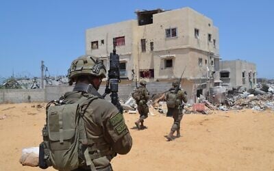 IDF soldiers operate in Khan Younis as the IDF expands its ground offensive in the Gaza Strip, June 5, 2025. (Stav Levaton/Times of Israel)