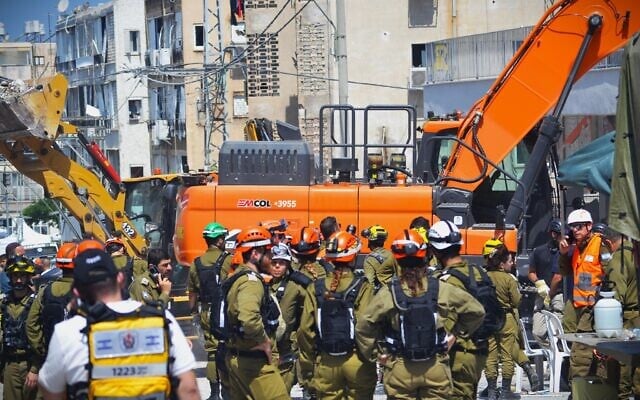 Rescue teams work to recover missing persons in a destroyed Bat Yam building following a deadly Iranian missile attack, June 15, 2025. (Stav Levaton/Times of Israel)