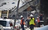 Israeli teams work to assess the damage and clear the rubble in Bnei Brak after a local school suffered a direct missile strike by Iran, June 16, 2025. (Stav Levaton/Times of Israel)