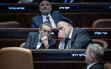 Shas party leader MK Aryeh Deri, right, speaks with United Torah Judaism No. 2 MK Moshe Gafni during a Knesset plenum session in Jerusalem, February 10, 2025. (Yonatan Sindel/Flash90)