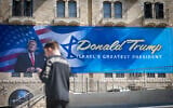 People walk next to a sign with a portrait of US President Donald Trump in central Jerusalem, May 7, 2025. (Yonatan Sindel/Flash90)
