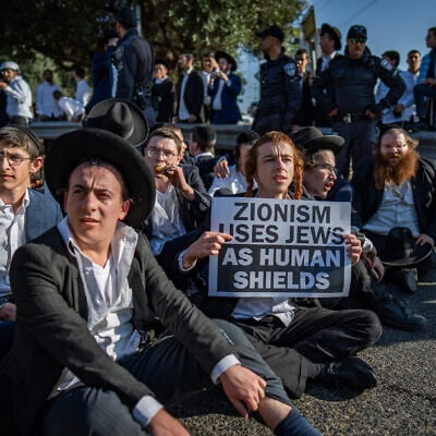 Ultra-Orthodox demonstrators clash with police during a protest against the drafting of Haredi youth near Bnei Brak, June 5, 2025. (Erik Marmor/Flash90)