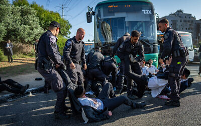 Ultra-Orthodox demonstrators clash with police during a protest against the drafting of Haredi youth near Bnei Brak, June 5, 2025. (Erik Marmor/Flash90)