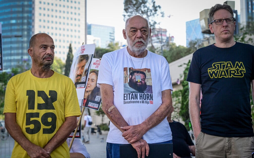 Itzik Horn (C), rather of captive Eitan Horn, and relatives of other Israeli hostages in Gaza hold a press conference outside the Kirya military base in Tel Aviv on June 7, 2025. (Avshalom Sassoni/Flash90)