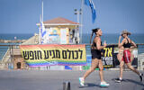 People jog in Tel Aviv, as the country braces for a potential retaliatory attack from Iran on Israel, after a wave of Israeli strikes on the Islamic Republic. June 13, 2025. (Avshalom Sassoni/FLASH90)
