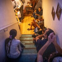 Israelis take cover in a public shelter in Jerusalem, during a ballistic missile attack fired from Iran into Israel on June 13, 2025. (Noam Revkin Fenton/FLASH90)