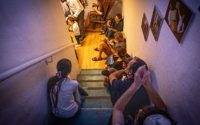 Israelis take cover in a public shelter in Jerusalem, during a ballistic missile attack fired from Iran into Israel on June 13, 2025. (Noam Revkin Fenton/FLASH90)