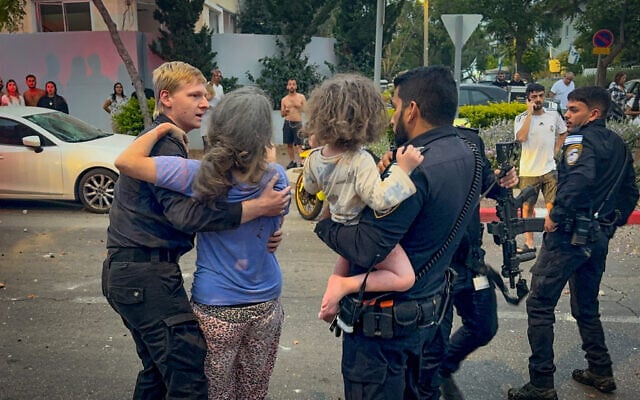 Police evacuate injured civilians at the scene where a ballistic missile fired from Iran hit and caused damage in Rishon Lezion, June 14, 2025. (Aloni Mor/Flash90) Police evacuate injured civilians at the scene where a ballistic missile fired from Iran hit and caused damage in Rishon Lezion, June 14, 2025. (Aloni Mor/Flash90)