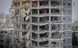 The scene of an apartment building destroyed by an Iranian ballistic missile impact, in Bat Yam, June 15, 2025. (Chaim Goldberg/Flash90)