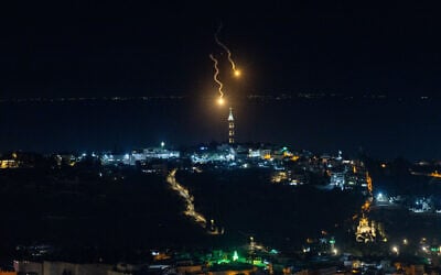 Shrapnel is seen falling over East Jerusalem on June 16, 2025. (Yonatan Sindel/Flash90)