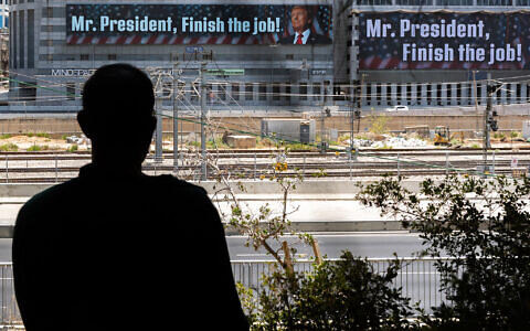 A message addressed to US President Donald Trump reading, 'Mr. President, finish the job,' is pictured in Tel Aviv on June 18, 2025. It is unclear who paid for the banner (Chaim Goldberg/Flash90)