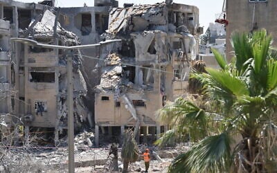 Rescue teams inspect the damage to buildings struck by an Iranian ballistic missile in Holon. Several Israelis were wounded, some of badly, in the strike, June 19, 2025. (Gili Yaari/Flash90)