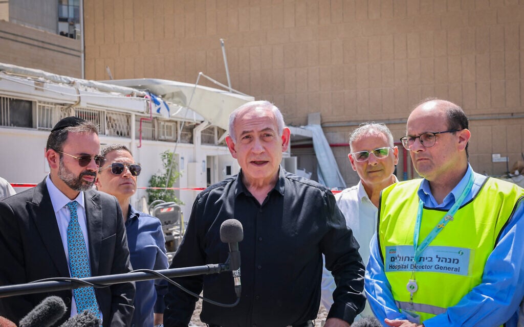 Prime Minister Benjamin Netanyahu at the scene of an Iranian missile strike on Soroka Medical Center in Beersheba, June 19, 2025. (Marc Israel Sellem/POOL/Flash90)