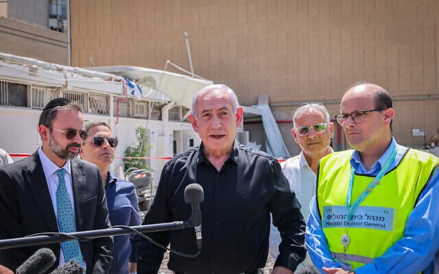 Prime Minister Benjamin Netanyahu at the scene of an Iranian missile strike on Soroka Medical Center in Beersheba, June 19, 2025. (Marc Israel Sellem/POOL/Flash90)