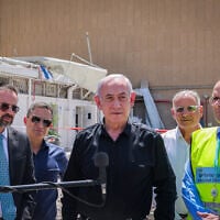 Prime Minister Benjamin Netanyahu visits the scene where a ballistic missile fired from Iran hit and caused damage at the Soroka Medical Center in Beersheba on June 19, 2025. (Marc Israel Sellem/Flash90)