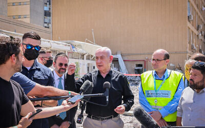 Prime Minister Benjamin Netanyahu at the scene of an Iranian missile strike on Soroka Medical Center in Beersheba, June 19, 2025. (Marc Israel Sellem/POOL/Flash90)