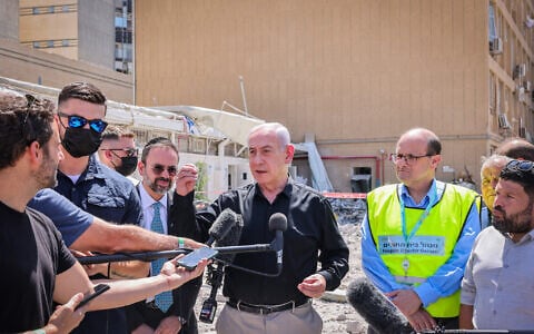 Prime Minister Benjamin Netanyahu at the scene of an Iranian missile strike on Soroka Medical Center in Beersheba, June 19, 2025. (Marc Israel Sellem/POOL/Flash90)