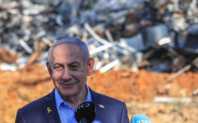 Prime Minister Benjamin Netanyahu visits the scene where an Iranian ballistic missile impacted, causing damage at the Weizmann Institute in Rehovot, June 20, 2025. (Itai Ron/Pool via Flash90)