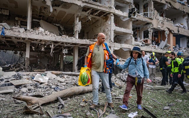 Israeli security and rescue forces at the scene where a ballistic missile fired from Iran hit and caused damage in Tel Aviv, June 22, 2025. (Chaim Goldberg/Flash90)