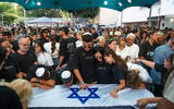 Family members and friends attend the funeral service of slain hostage Yonatan Samerano in Tel Aviv, June 24, 2025. (Chaim Goldberg/Flash90)