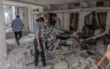 A property owner surveys damage in Bat Yam on June 24, 2025. (Chaim Goldberg/FLASH90)