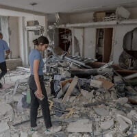 A property owner surveys damage in Bat Yam on June 24, 2025. (Chaim Goldberg/FLASH90)
